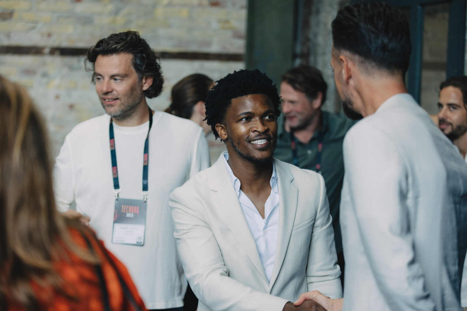 Two-men-in-white-shirts-shaking-hands-at-TechBBQ